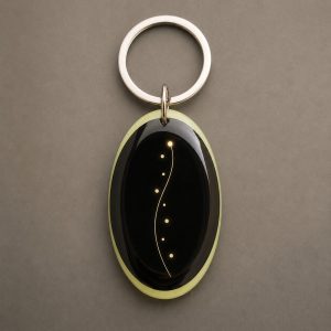 Chemin de Lumière, trajectoire minimaliste, une courbe dorée et plusieurs points de lumière, porte-clés photoluminescent en lumière naturelle